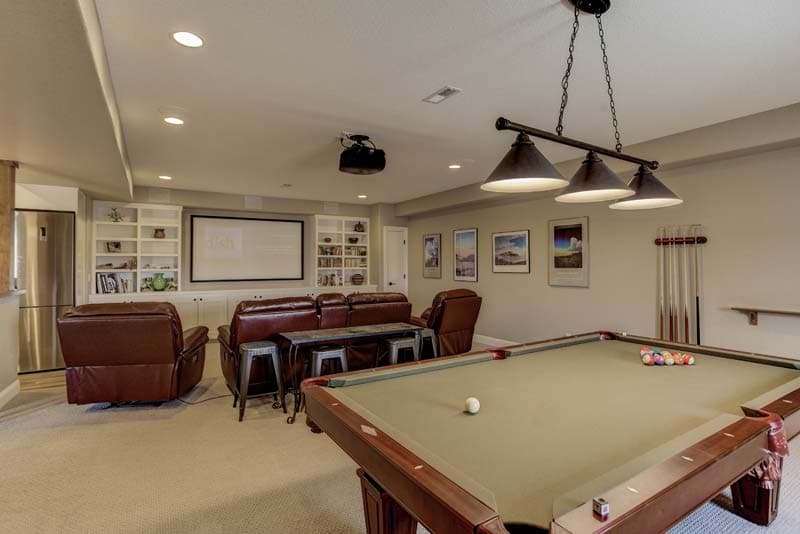 Basement with a pool table and theater seating