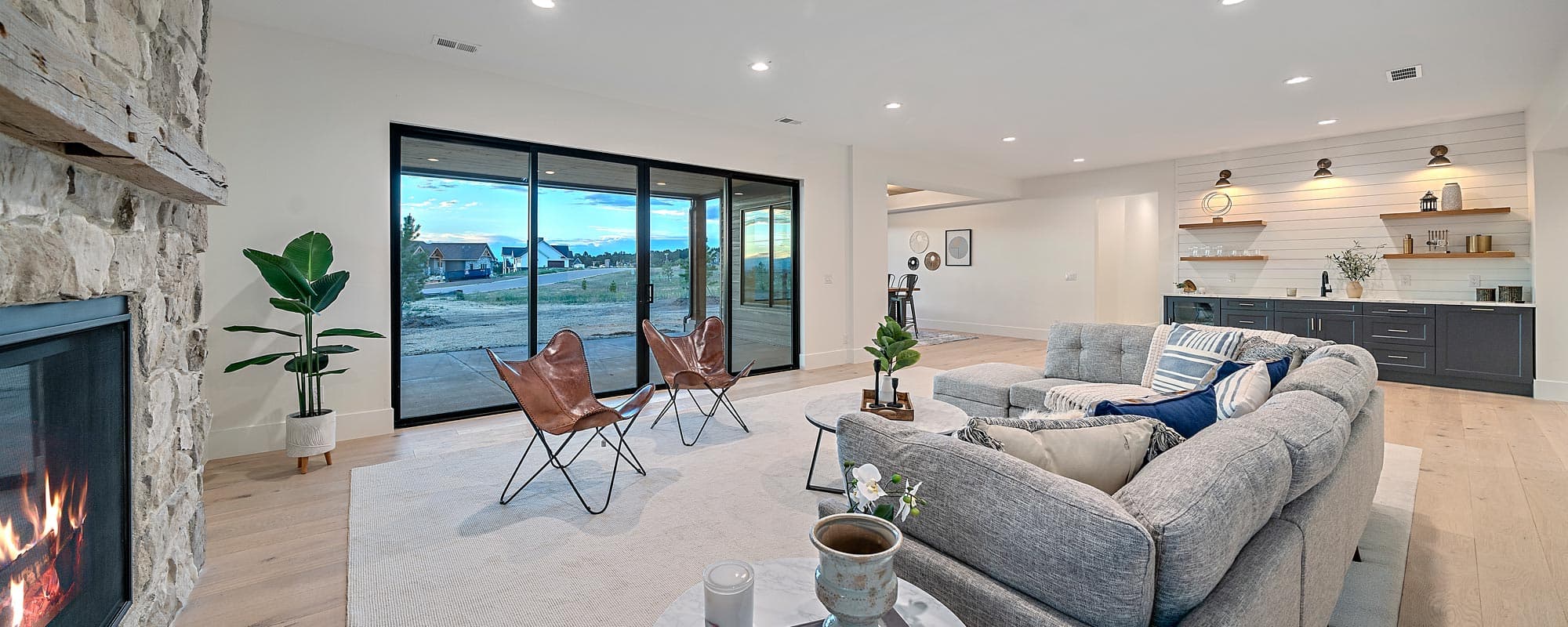 Bright finished walk-out basement with a stone fireplace, a wet bar and sliding doors open to the yard
