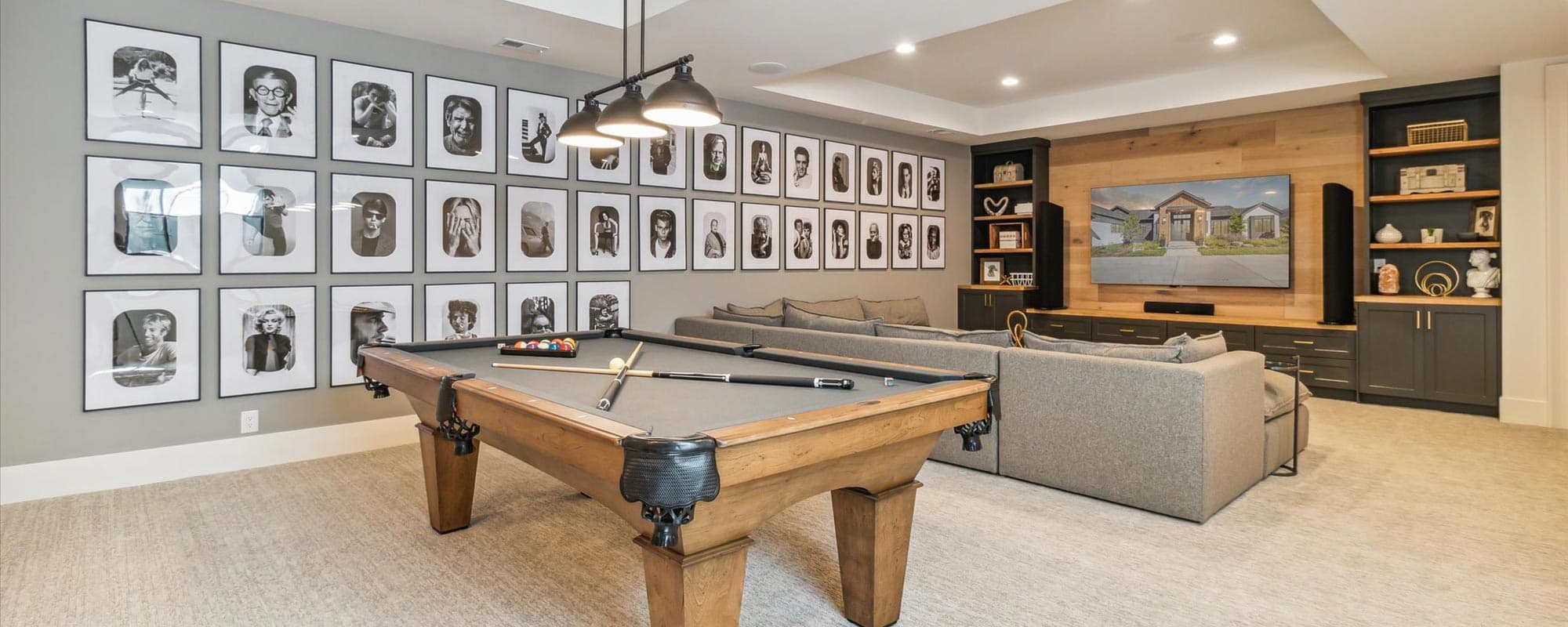 Finished basement game room with a pool table and a wood accent wall